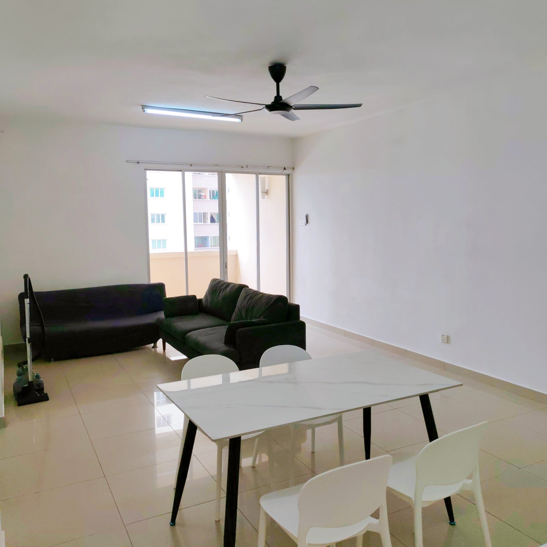 Living room with sofa and dining table of a furnished 3 rooms house for rent at Aman Heights, Seri Kembangan