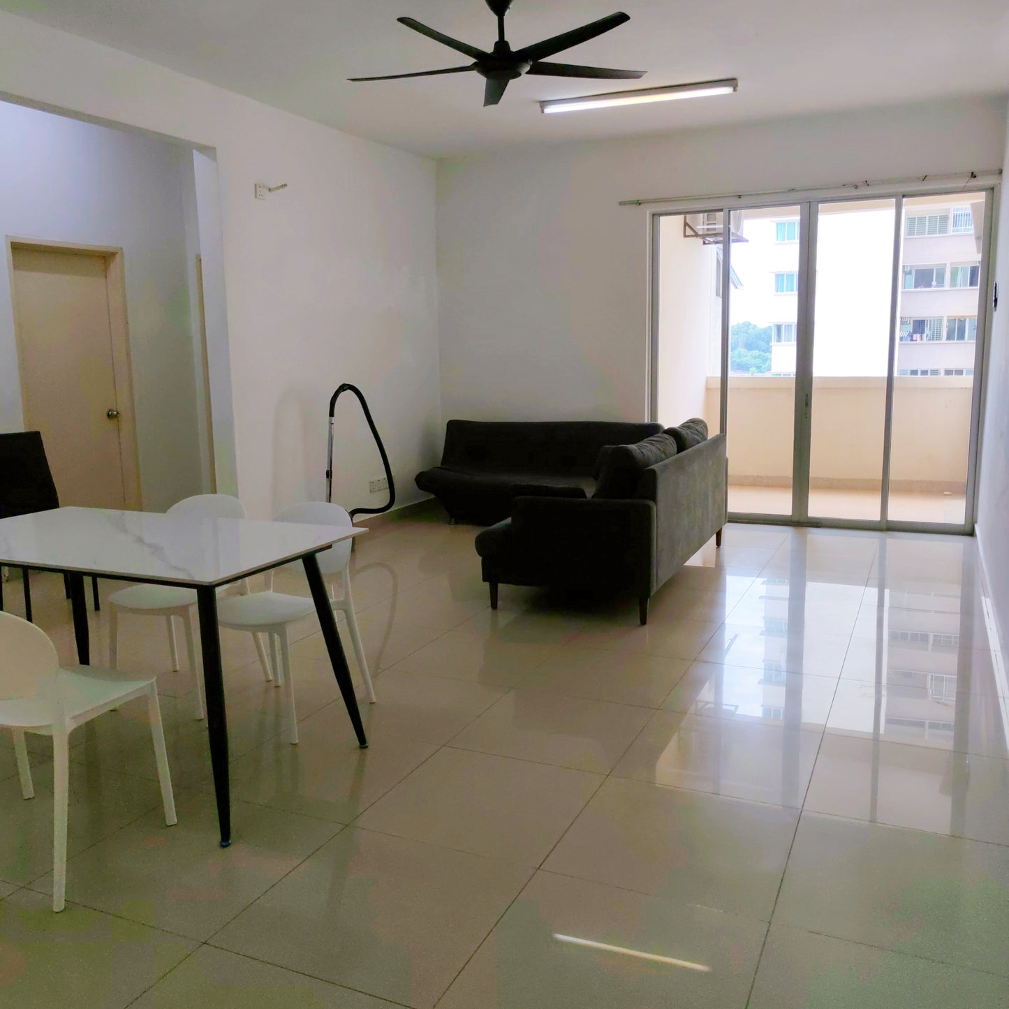 Overall view of a living area over looking a balcony at a furnished house for rent at Aman Heights Seri Kembangan