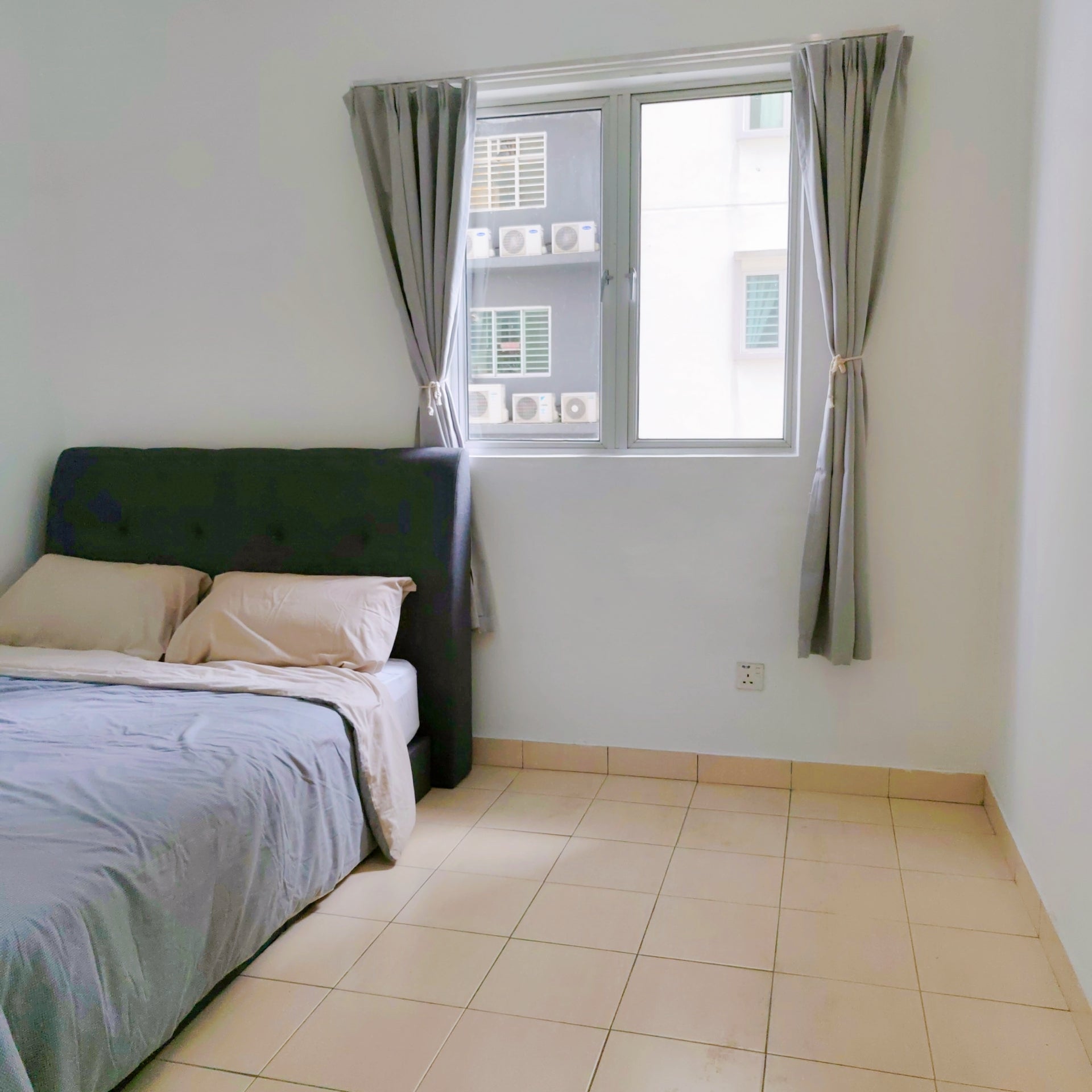 Middle room inside a house for rent with windows overlooking opposite building at Aman Heights