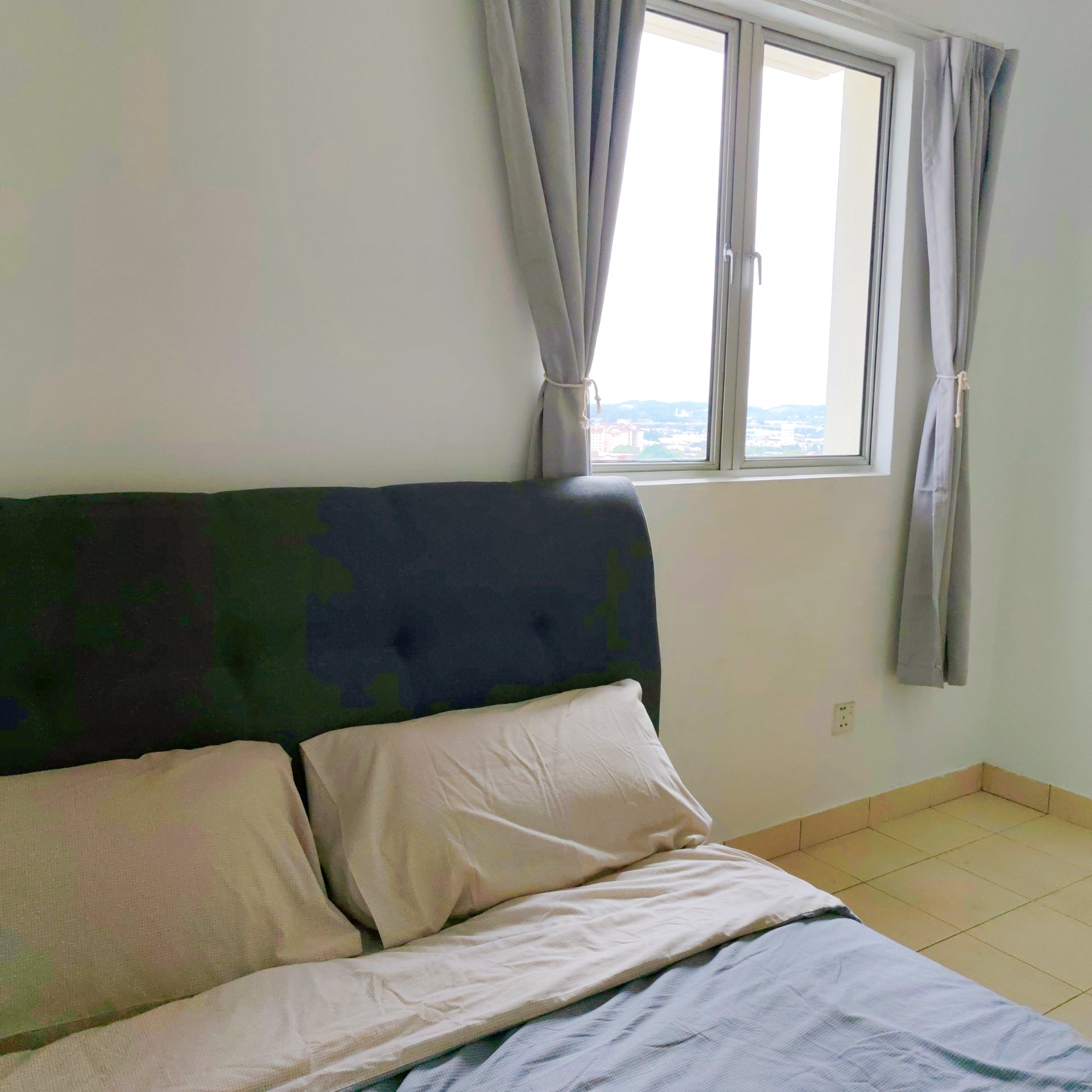 A nice bed in room inside a house for rent with windows overlooking opposite building at Aman Heights